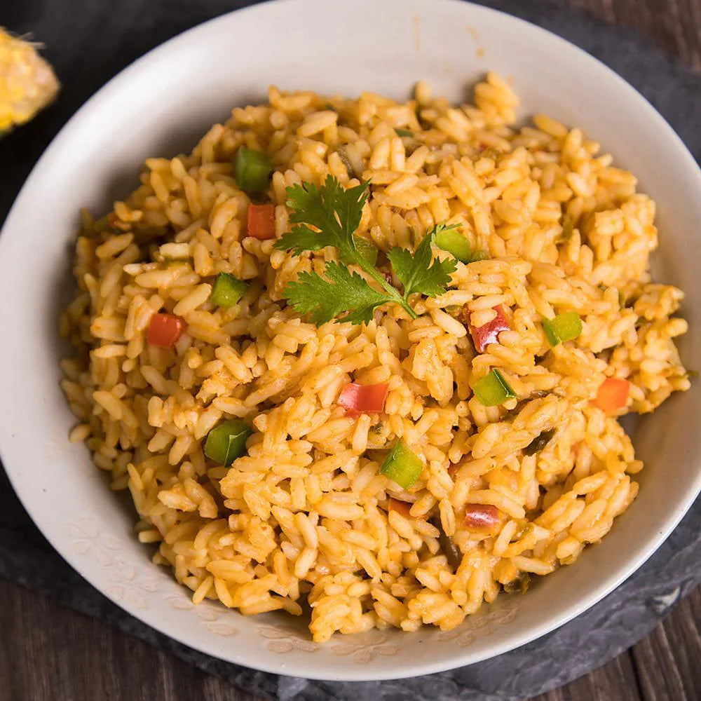 southwest rice with cilantro garnish on top in white bowl