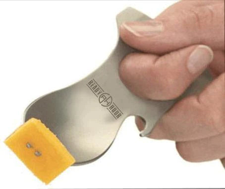 grub n tool being used as a fork to pickup food