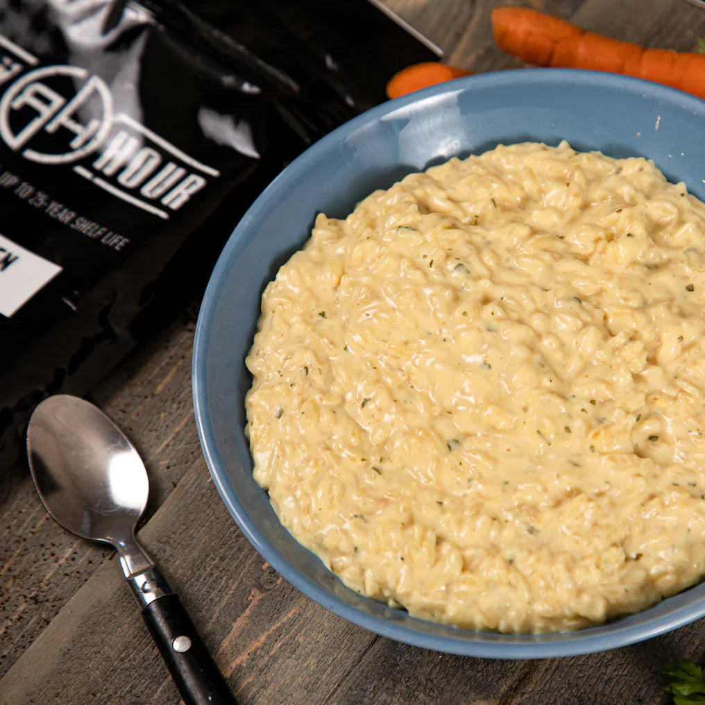 maple grove oatmeal in blue bowl with silver spoon on left side and carrots on right
