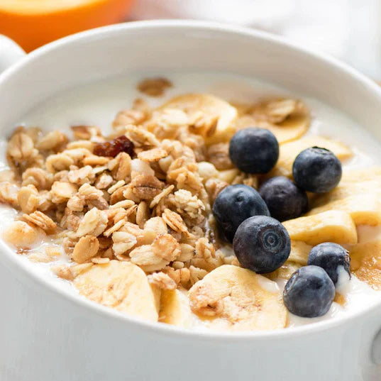 quick oats in white bowl with banana blueberry and granola on top