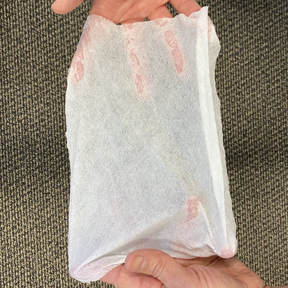 ready hour compressed hand towel being stretched by two hands