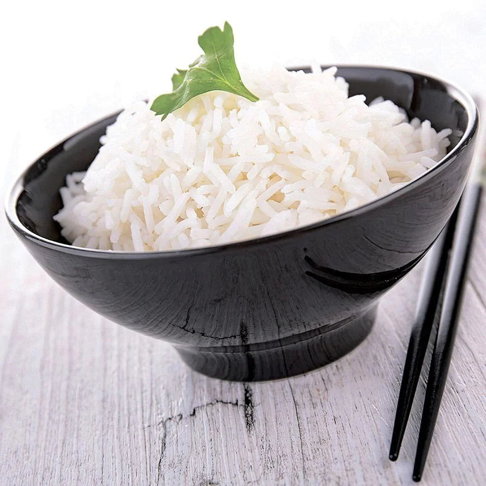 long grain white rice with green garnish on top in black bowl with black chopsticks on the side